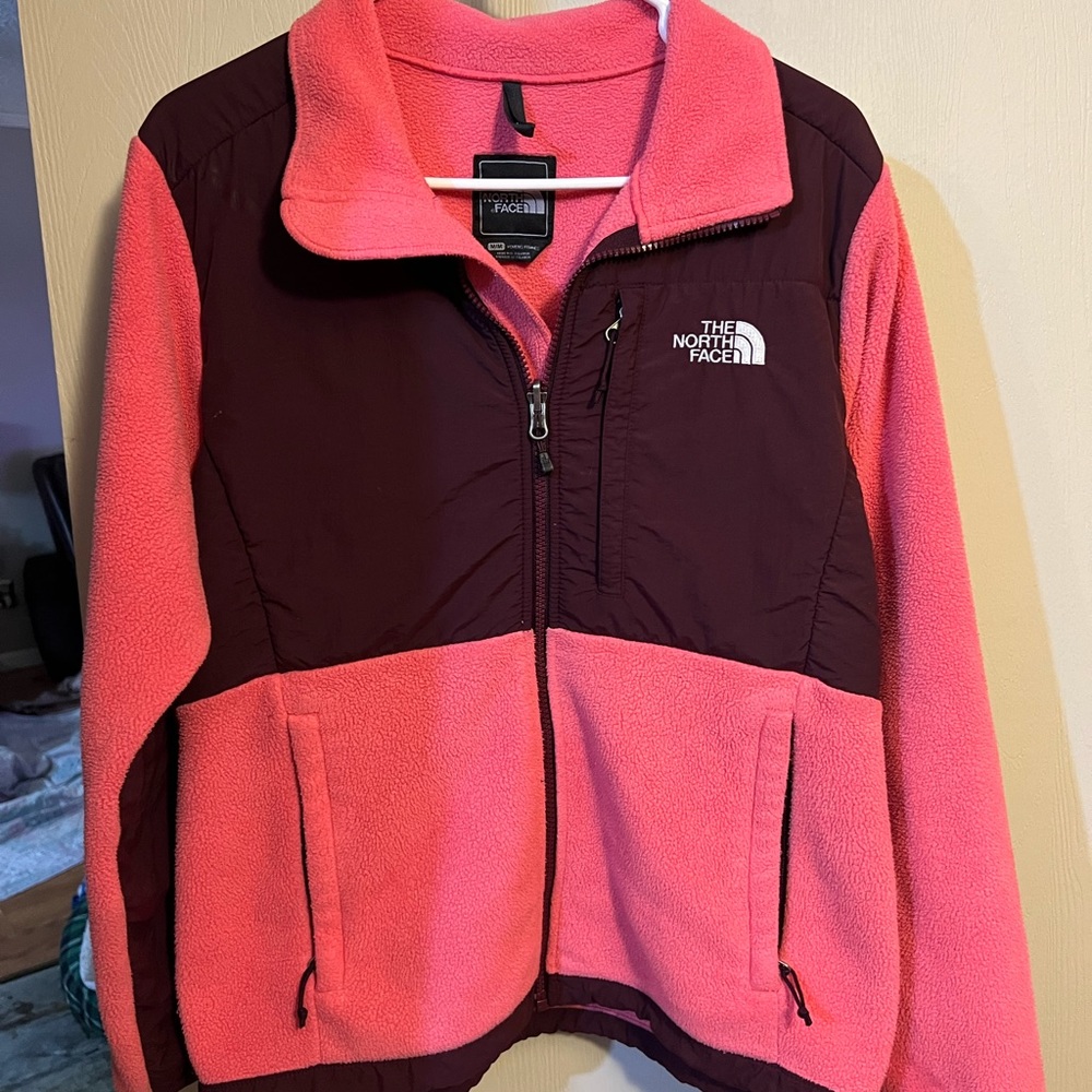 Women’s north face. Kind of a coral color.